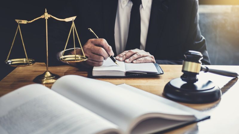 male-lawyer-or-judge-working-with-contract-papers.jpg